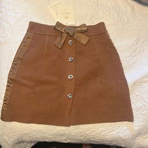 Brown skirt with buttons and tie.